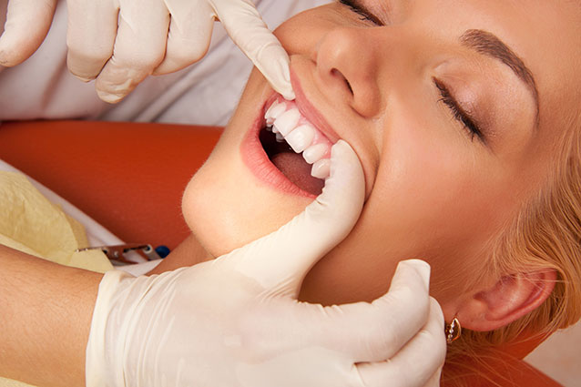 Dentist checking a patients gums
