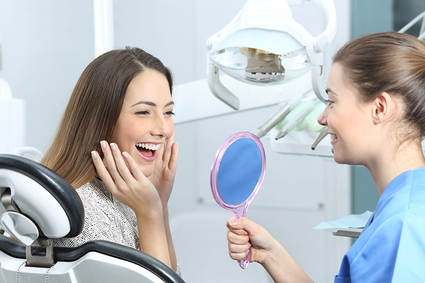 Happy Patient looking in Mirror